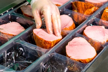 Meat Being Placed into Containers