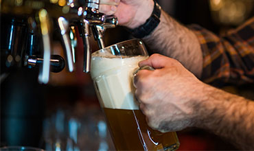 Man pouring beer off tap