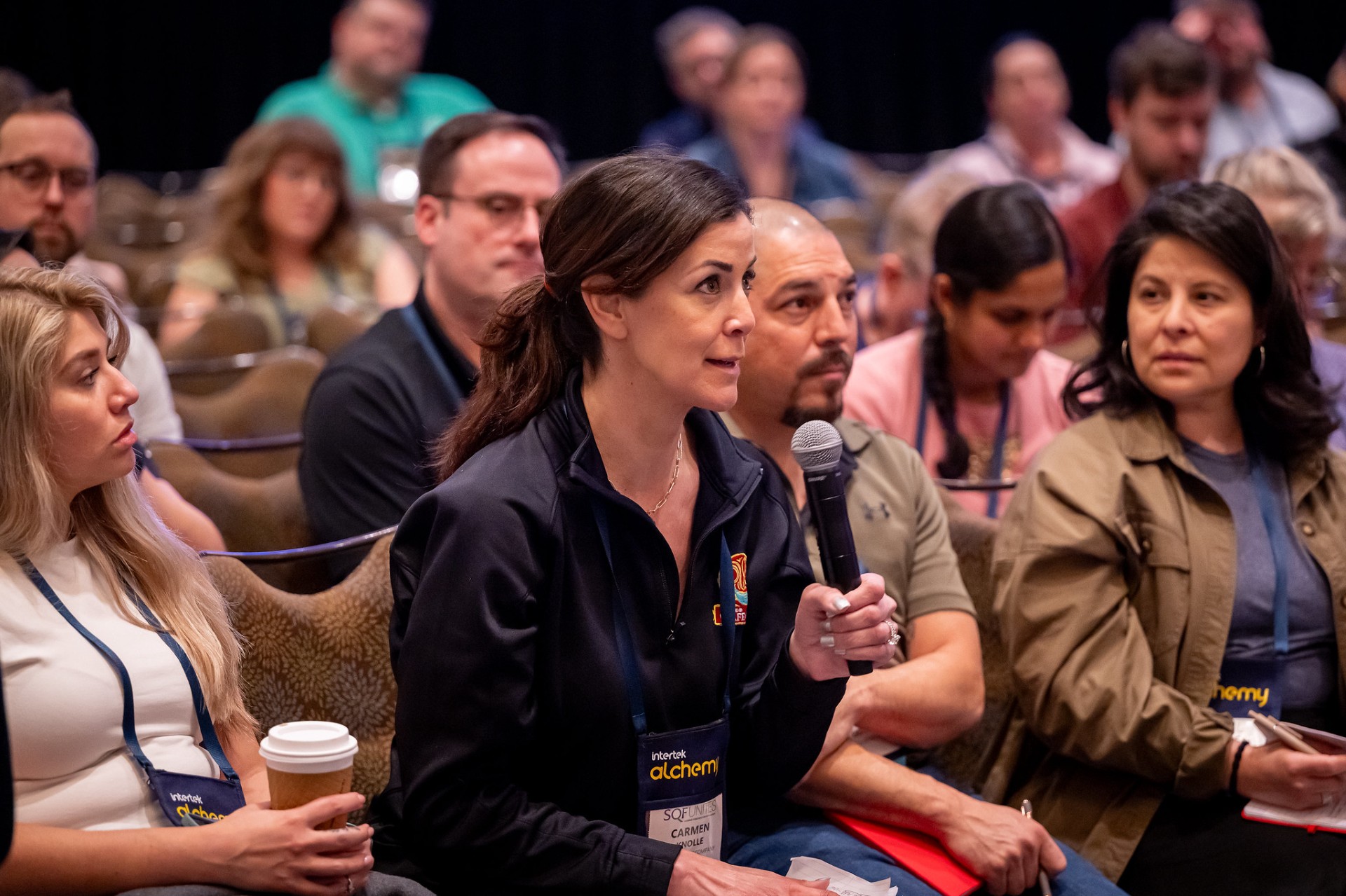 three people conversing in a booth
